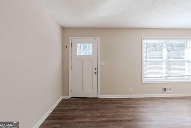 entrance foyer featuring a textured ceiling and dark hardwood / wood-style floors