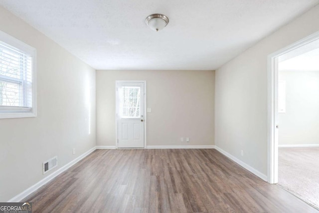 unfurnished room featuring dark hardwood / wood-style flooring