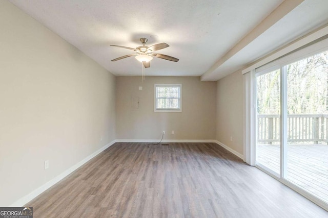 spare room with ceiling fan and light hardwood / wood-style floors