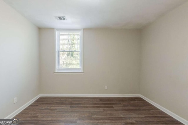 unfurnished room featuring dark hardwood / wood-style flooring