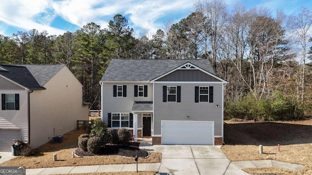 front of property featuring central air condition unit and a garage