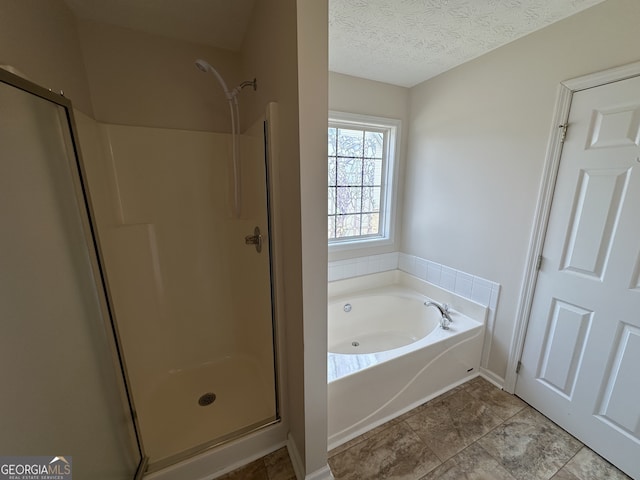 bathroom with a textured ceiling, tile patterned floors, and independent shower and bath