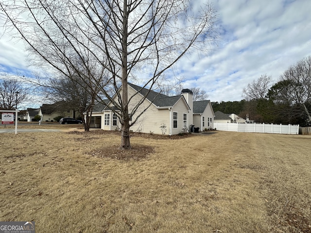 view of home's exterior with a lawn