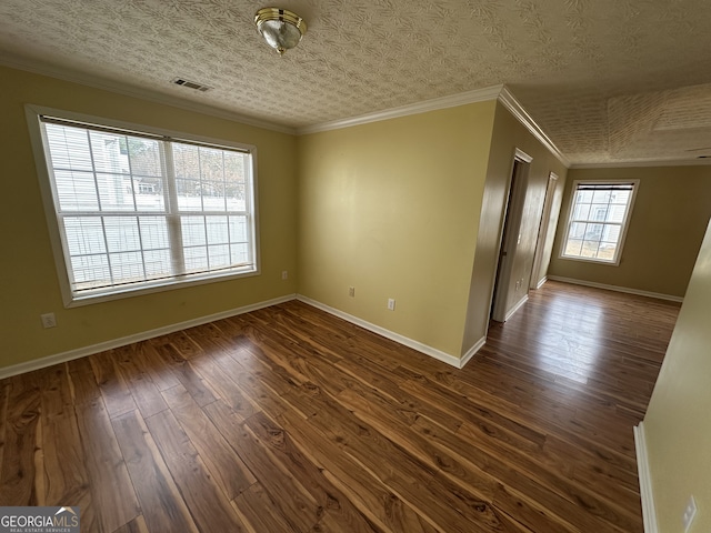 unfurnished room with a textured ceiling, dark hardwood / wood-style floors, and ornamental molding