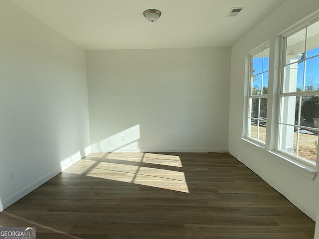 spare room featuring dark wood-type flooring