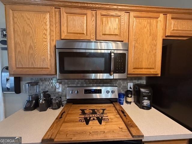 kitchen featuring tasteful backsplash and butcher block countertops