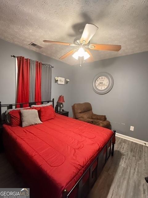 bedroom featuring a textured ceiling, hardwood / wood-style flooring, and ceiling fan