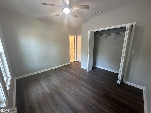 unfurnished bedroom featuring dark hardwood / wood-style flooring, a closet, and ceiling fan