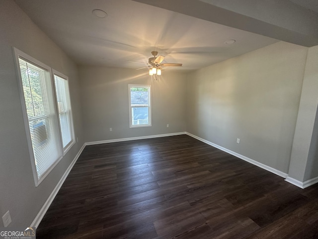 unfurnished room with ceiling fan and dark wood-type flooring