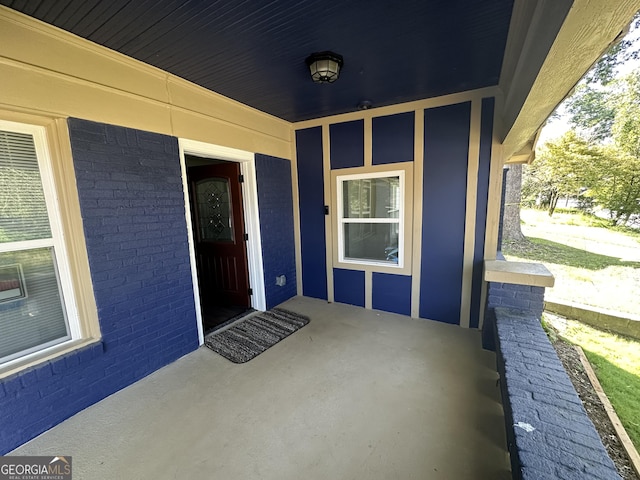 view of exterior entry with covered porch