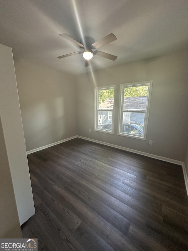 unfurnished room with ceiling fan and dark hardwood / wood-style flooring