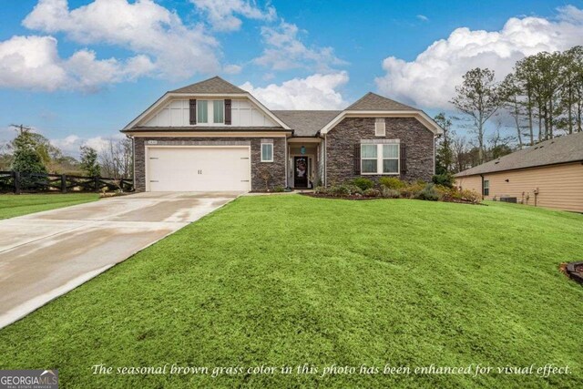 view of front of property with a front lawn and a garage