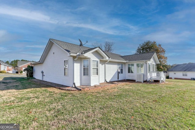 view of front of property with central air condition unit, a wooden deck, and a front yard