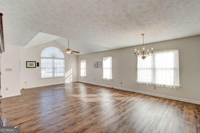 unfurnished room featuring a textured ceiling, ceiling fan with notable chandelier, lofted ceiling, and dark wood-type flooring