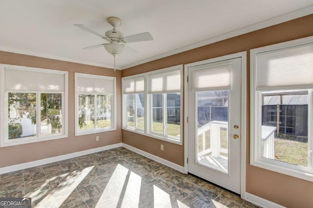 unfurnished sunroom with ceiling fan