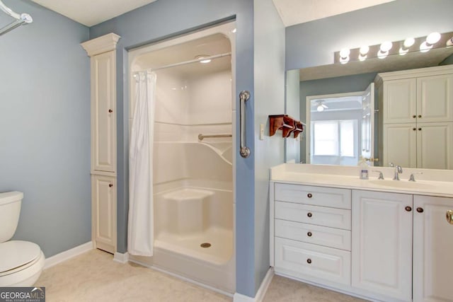 bathroom with toilet, vanity, and walk in shower