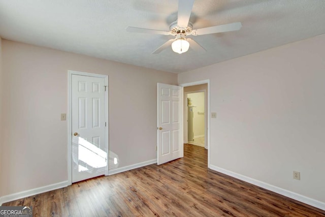 spare room with hardwood / wood-style flooring and ceiling fan