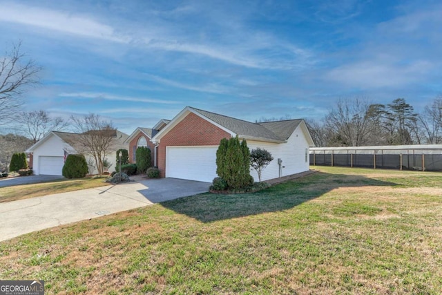 view of side of home featuring a lawn and a garage