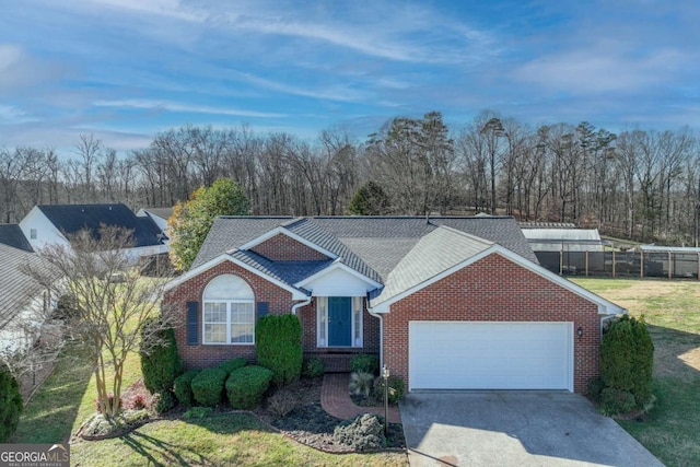 single story home with a front yard and a garage