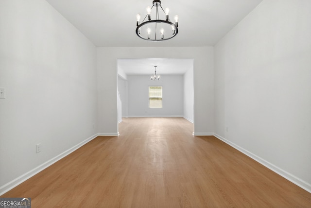 interior space with an inviting chandelier and light hardwood / wood-style flooring