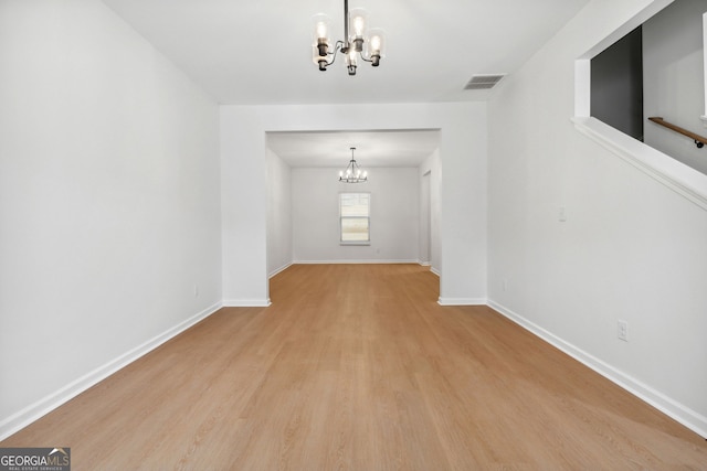 interior space featuring light hardwood / wood-style flooring and a notable chandelier