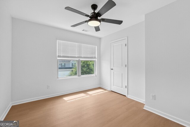 unfurnished room with ceiling fan and light wood-type flooring