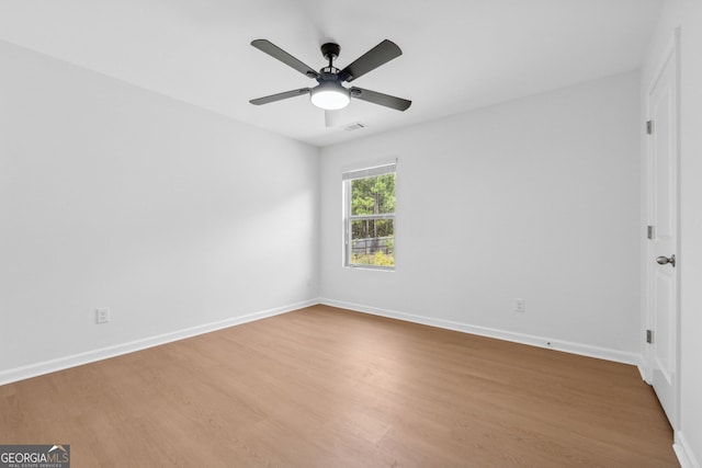 spare room with hardwood / wood-style floors and ceiling fan