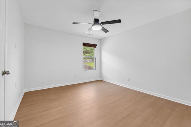 spare room with light hardwood / wood-style floors and ceiling fan