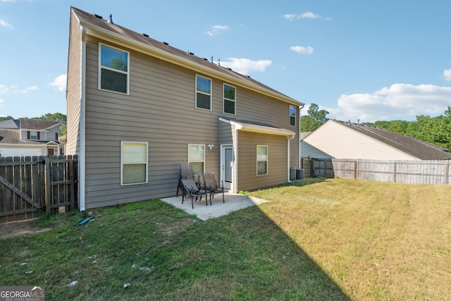 rear view of property with cooling unit, a lawn, and a patio