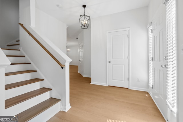 staircase featuring a notable chandelier and hardwood / wood-style floors