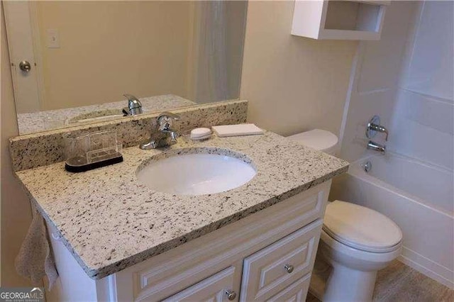 full bathroom featuring shower / bath combination, vanity, and toilet