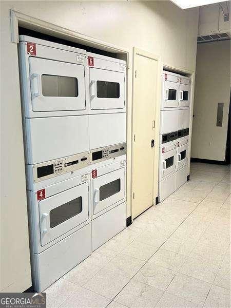 kitchen featuring stacked washer and dryer