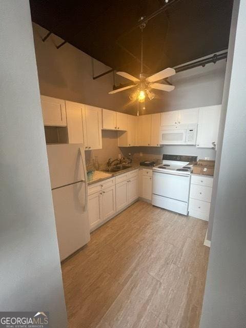 kitchen with white cabinets, white appliances, and light hardwood / wood-style flooring