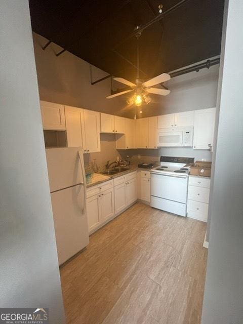 kitchen with white cabinetry, white appliances, and light hardwood / wood-style flooring