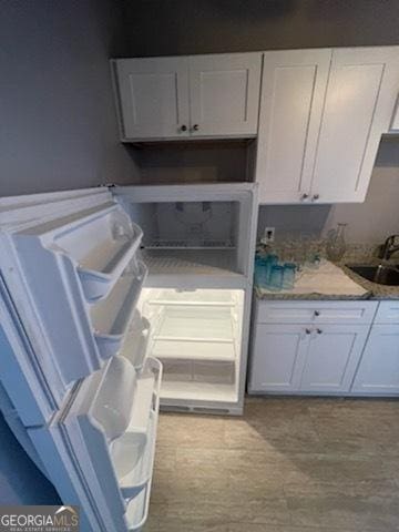 kitchen featuring sink and white cabinets