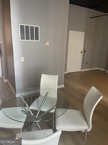 dining space featuring wood-type flooring