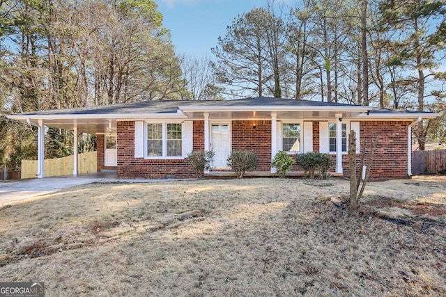 single story home featuring a front yard and a carport