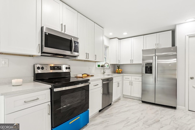 kitchen featuring sink, white cabinetry, and stainless steel appliances