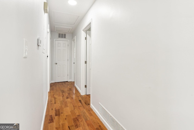 corridor with light hardwood / wood-style floors