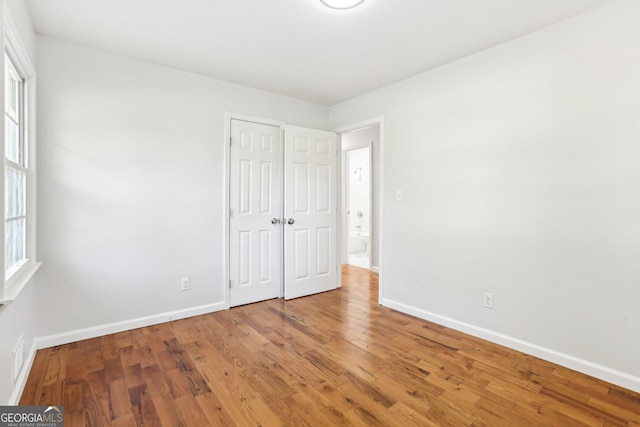 unfurnished bedroom with hardwood / wood-style flooring