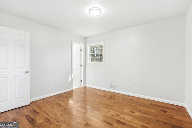 unfurnished room featuring hardwood / wood-style flooring