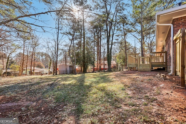 view of yard with a wooden deck