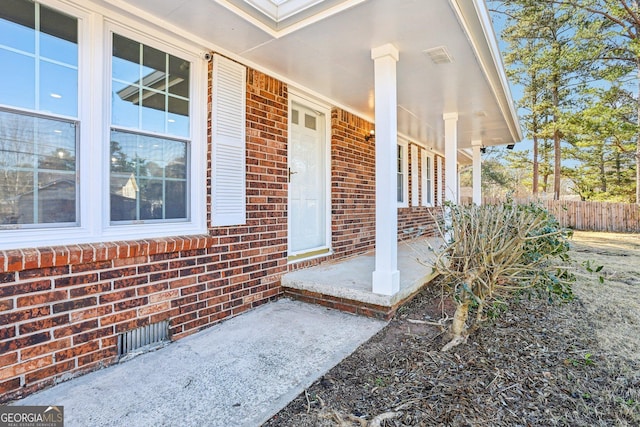 view of exterior entry featuring a porch