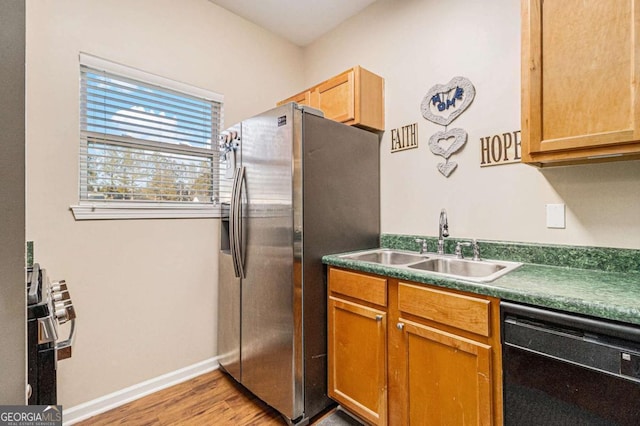 kitchen with light hardwood / wood-style floors, sink, black dishwasher, and stainless steel refrigerator with ice dispenser