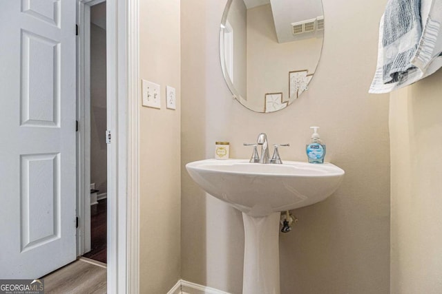 bathroom with hardwood / wood-style flooring