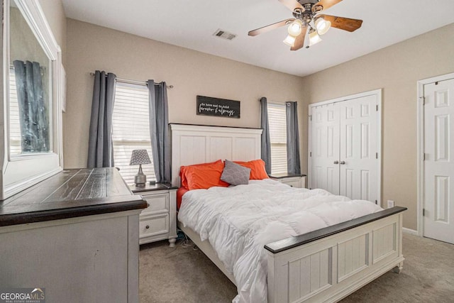 carpeted bedroom featuring a closet and ceiling fan