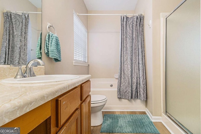 full bathroom with vanity, separate shower and tub, and toilet