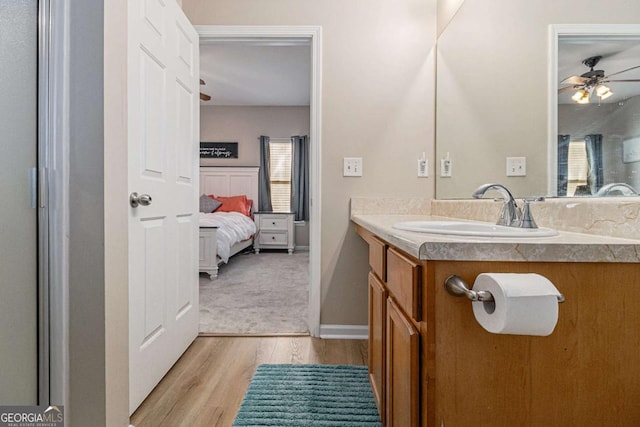 bathroom featuring hardwood / wood-style floors, ceiling fan, and vanity