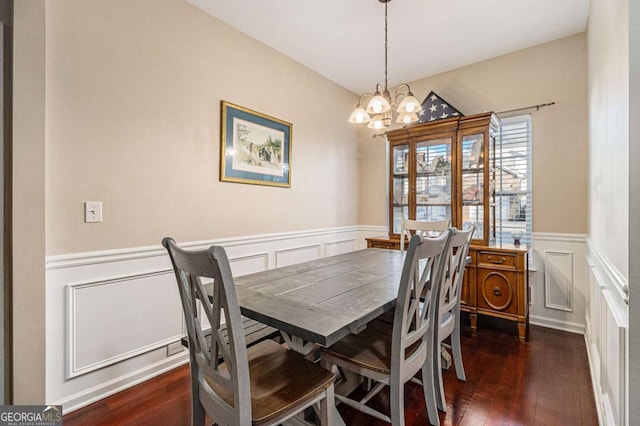 dining space featuring a chandelier and dark hardwood / wood-style flooring