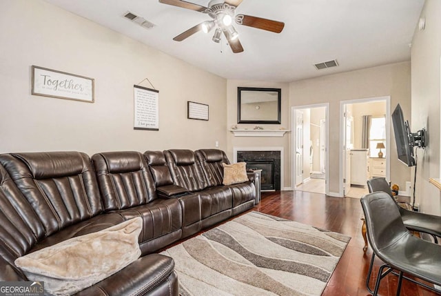 living room featuring ceiling fan and hardwood / wood-style floors